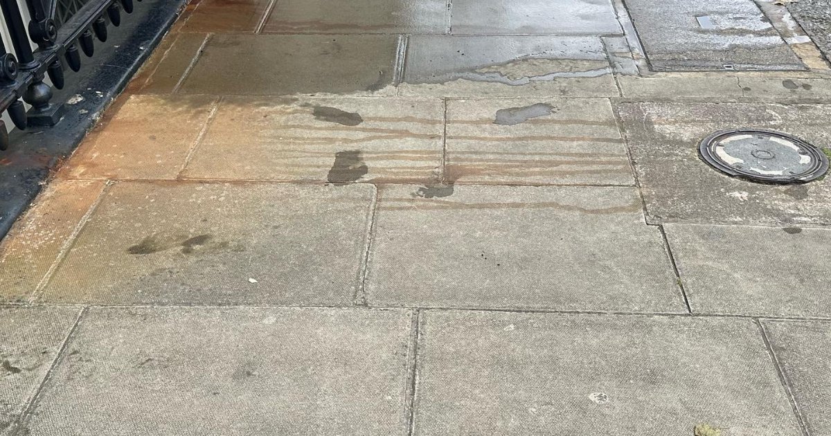 Wet stone paving slabs on a London pavement after cleaning
