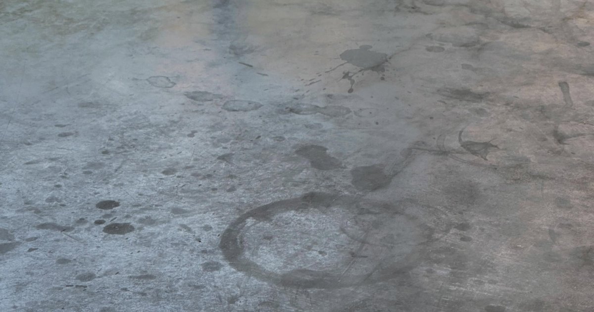 Grey stone worktop with water rings beside an undermount sink