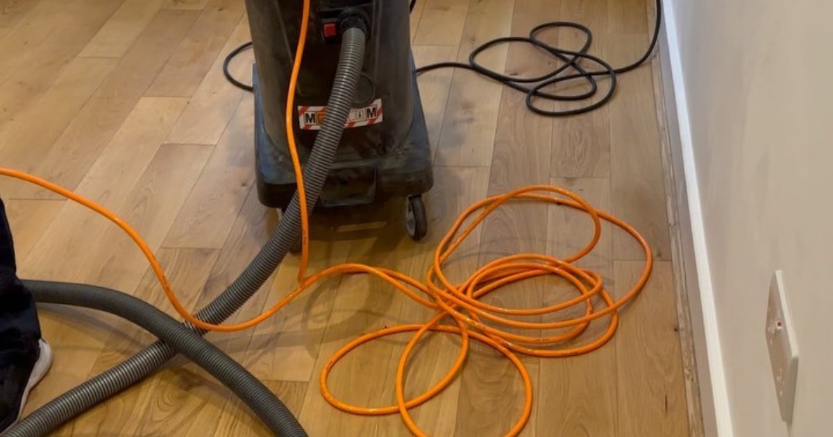Dust extractor on an oak floor during restoration work
