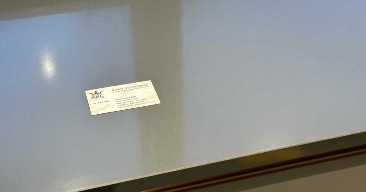 White engineered quartz worktop with a fabricator’s card on the surface