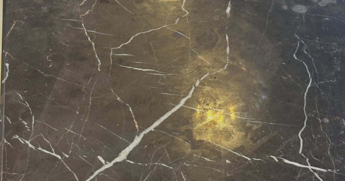 Close-up of polished dark marble with natural white veining