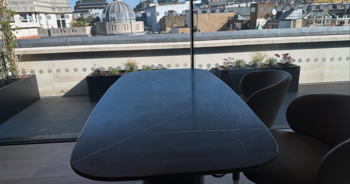 Dark stone-effect table on a rooftop terrace overlooking London